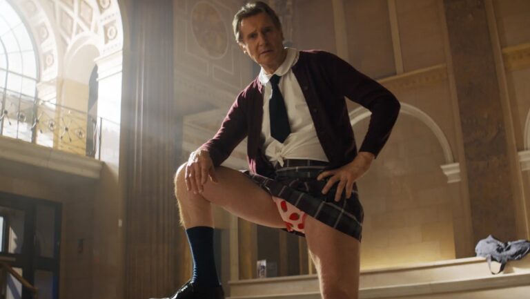 Liam Neeson introduces himself as “Frank Drebin, Jr, Police Squad,” in a scene from ‘The Naked Gun’