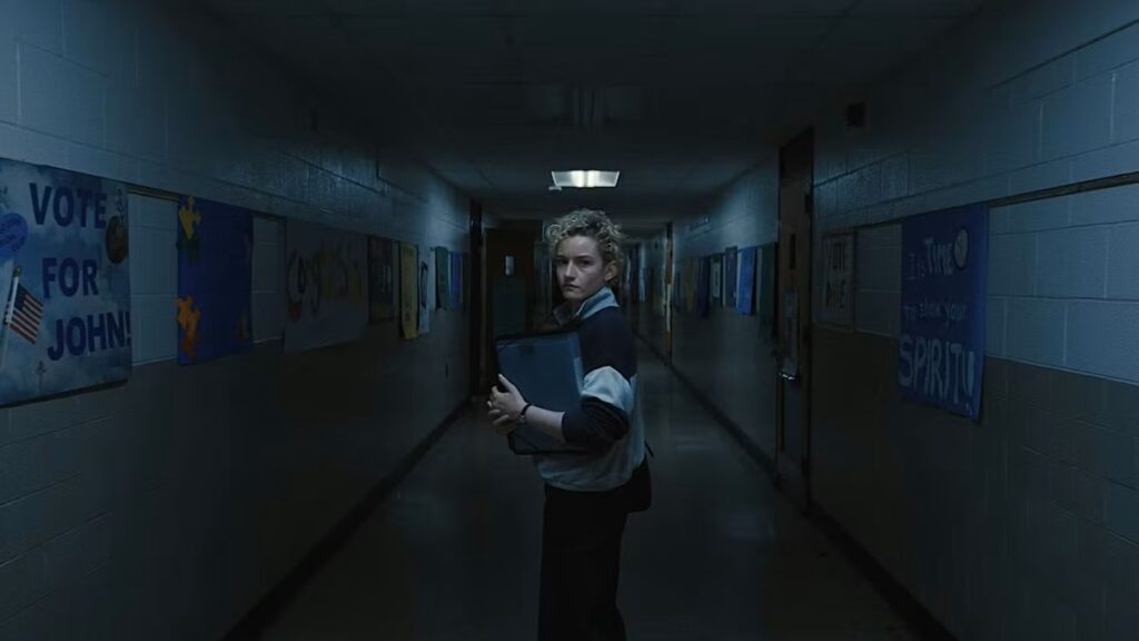 Justine Gandy (Julia Garner) walking in the school corridor at night