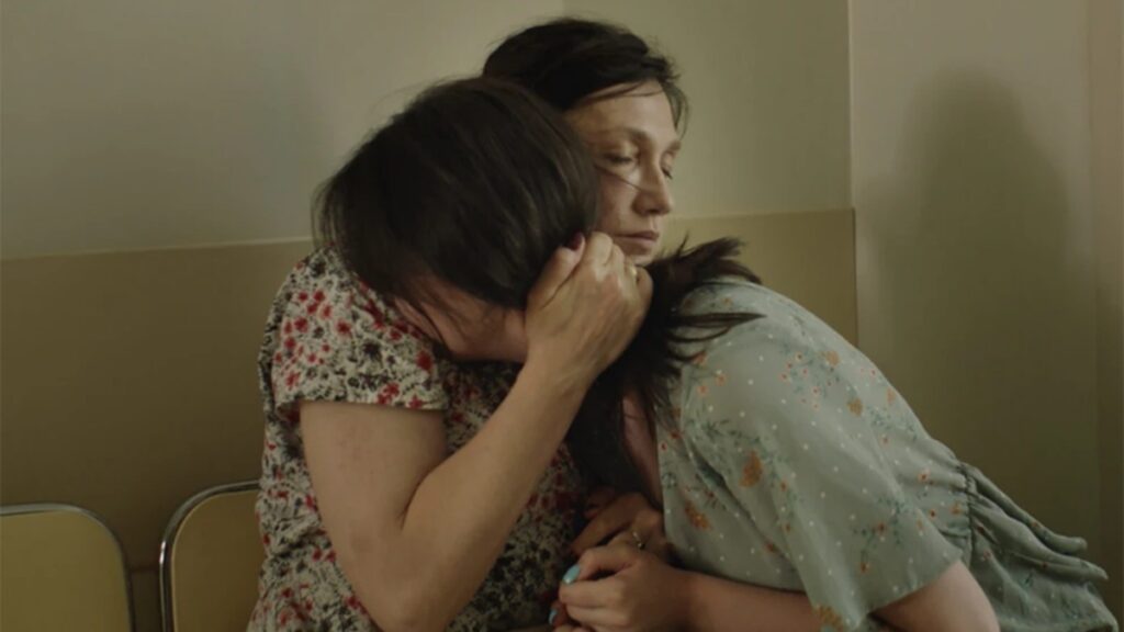 Mila comforts Kasia after a hospital visit