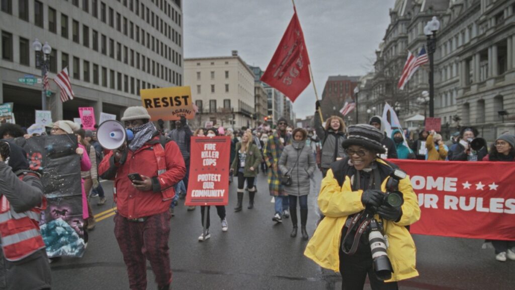 Sharon Farmer in the middle of the People's March, in a scene from Tough Old Broads.
