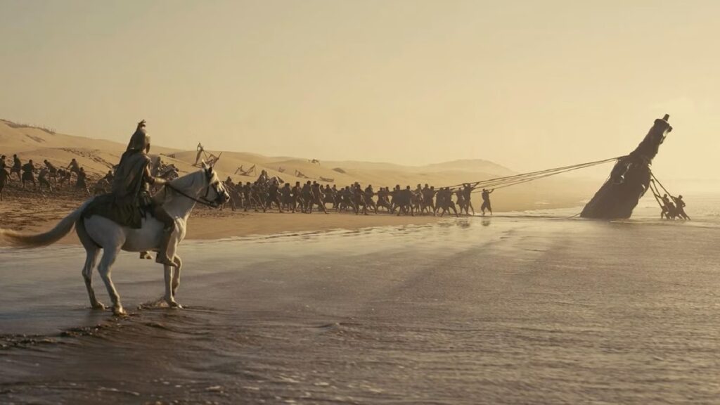 The Trojans pull the horse from the beach.