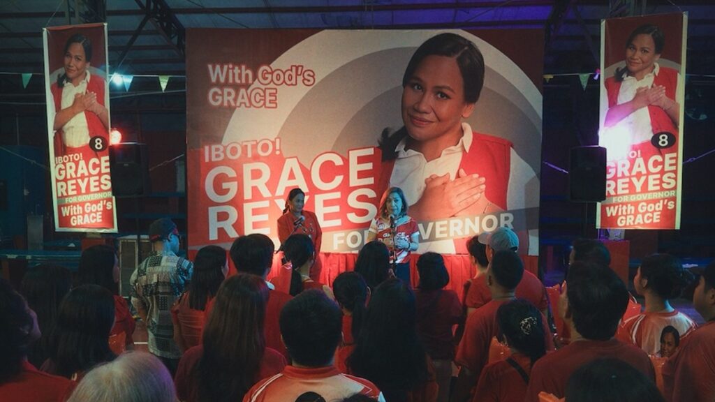 Bituin Escalante portrays gubernatorial candidate Grace Reyes onstage, alongside Ofel Peralta (Frances Makil-Ignacio).